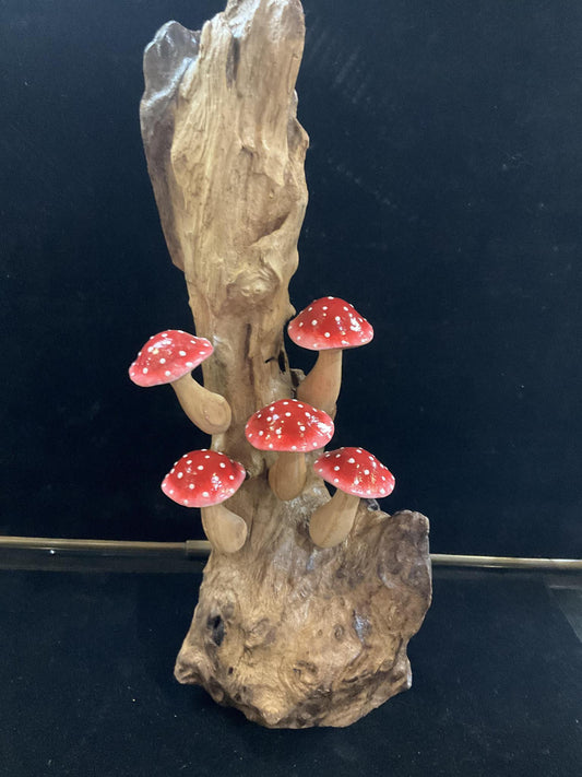 Red Carved Mushrooms on Driftwood